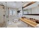 Modern bathroom with a glass shower, white shiplap walls, vessel sink and decorative stone accents at 7470 Eldora Av, Las Vegas, NV 89117