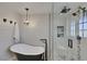Bathroom featuring a standalone tub, a glass shower with double shower heads and decorative tiling at 7470 Eldora Av, Las Vegas, NV 89117