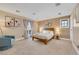 Spacious bedroom with warm tones and decor with comfortable seating at 7470 Eldora Av, Las Vegas, NV 89117