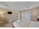 Comfortable bedroom featuring neutral walls, a flatscreen tv and a cozy bed with fresh, rolled white towels at 7470 Eldora Av, Las Vegas, NV 89117