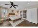 Inviting bedroom with natural light, a ceiling fan, and double doors to another room or closet at 7470 Eldora Av, Las Vegas, NV 89117