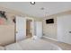 Neutral bedroom featuring a comfortable bed, flatscreen tv, and white closet and doors at 7470 Eldora Av, Las Vegas, NV 89117