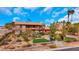 Southwestern style two-story home featuring landscaped grounds and a vibrant green lawn at 7470 Eldora Av, Las Vegas, NV 89117
