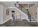 Spacious foyer with slate flooring, a modern staircase, and a decorative console table at 7470 Eldora Av, Las Vegas, NV 89117