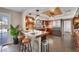 Rustic kitchen featuring wood cabinetry, stainless steel appliances, and a cozy breakfast bar with seating at 7470 Eldora Av, Las Vegas, NV 89117