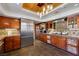 Well-appointed kitchen with custom cabinets, stone backsplash and stainless steel refrigerator at 7470 Eldora Av, Las Vegas, NV 89117