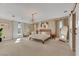 Bright main bedroom with large windows, ensuite bathroom with sliding barn door, and modern decor at 7470 Eldora Av, Las Vegas, NV 89117
