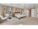 Spacious main bedroom featuring a seating area and a barn door leading to an ensuite bathroom at 7470 Eldora Av, Las Vegas, NV 89117
