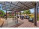 A lovely outdoor patio features covered seating and mature landscaping at 7470 Eldora Av, Las Vegas, NV 89117