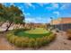The backyard of this property features a beautiful putting green with mature landscaping at 7470 Eldora Av, Las Vegas, NV 89117