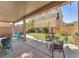 Inviting covered patio with artificial grass, string lights, and lush landscaping for outdoor enjoyment at 756 Arden Valley Ave, Henderson, NV 89011