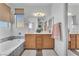 Bright bathroom with a double vanity, soaking tub with decorative tile, and a large mirror at 756 Arden Valley Ave, Henderson, NV 89011