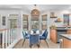 Cozy breakfast nook featuring modern light fixture and views of backyard landscaping through large windows at 756 Arden Valley Ave, Henderson, NV 89011