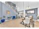 Open concept foyer with soaring ceilings, contemporary lighting, staircase, and decorative dining table set at 756 Arden Valley Ave, Henderson, NV 89011