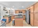 Updated kitchen with modern stainless steel appliances, warm wood cabinets, and a functional center island at 756 Arden Valley Ave, Henderson, NV 89011
