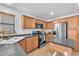 Well-appointed kitchen featuring granite counters, stainless steel appliances, and natural wood cabinetry at 756 Arden Valley Ave, Henderson, NV 89011