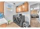 Laundry room features modern gray washer and dryer and built-in cabinets at 756 Arden Valley Ave, Henderson, NV 89011
