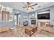 Inviting living room with ceiling fan, a decorative fireplace, and comfortable seating arrangements at 756 Arden Valley Ave, Henderson, NV 89011