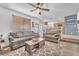Comfortable living room featuring ceiling fan, wood floors, comfortable seating, and seamless kitchen access at 756 Arden Valley Ave, Henderson, NV 89011