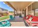 Covered patio with stylish outdoor furniture, artificial turf, and a well-manicured backyard at 756 Arden Valley Ave, Henderson, NV 89011
