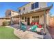 Relaxing covered patio with ample seating and artificial turf, perfect for outdoor entertaining at 756 Arden Valley Ave, Henderson, NV 89011
