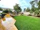 Expansive backyard featuring lush green lawn, charming fountain, and inviting seating area at 7625 Coley Ave, Las Vegas, NV 89117