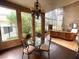Dining room with modern chandelier and a curved wall of windows at 7625 Coley Ave, Las Vegas, NV 89117