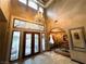 Grand foyer with high ceilings, ornate chandelier, custom ironwork, arched doorways, and elegant tile flooring at 7625 Coley Ave, Las Vegas, NV 89117