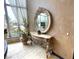 Foyer with ornate console table and mirror next to window at 7625 Coley Ave, Las Vegas, NV 89117
