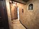 Hallway featuring an arched doorway, decorative niche and staircase at 7625 Coley Ave, Las Vegas, NV 89117
