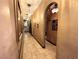 Hallway with decorative lighting, art niches, neutral color scheme, and tile flooring at 7625 Coley Ave, Las Vegas, NV 89117