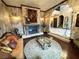 Cozy living room with a decorative fireplace, plush seating, and a view of the second-story landing through an arched doorway at 7625 Coley Ave, Las Vegas, NV 89117