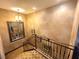 Elegant staircase with decorative wrought iron railing and a large mirror at 7625 Coley Ave, Las Vegas, NV 89117