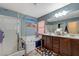 Bright bathroom with a glass-enclosed shower, a soaking tub, and a double sink vanity at 7651 Anatolian St, Las Vegas, NV 89166