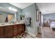Bathroom featuring a double sink vanity with cherry cabinets at 7651 Anatolian St, Las Vegas, NV 89166