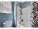 Bathroom featuring a white shower/tub and toilet under a window at 7651 Anatolian St, Las Vegas, NV 89166