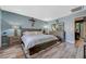 Cozy bedroom featuring a large bed, side tables, and wood-look flooring at 7651 Anatolian St, Las Vegas, NV 89166