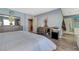 Stylish bedroom with light blue walls, modern furnishings, and wood-look flooring at 7651 Anatolian St, Las Vegas, NV 89166