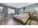 Comfortable bedroom featuring a spacious bed, wood-look flooring, and a bright window at 7651 Anatolian St, Las Vegas, NV 89166
