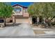Two-story home with a two-car garage and drought-resistant landscaping at 7651 Anatolian St, Las Vegas, NV 89166