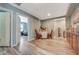 Inviting hallway with hardwood floors leading to a cozy bedroom and a charming table setup at 7651 Anatolian St, Las Vegas, NV 89166