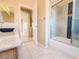 Bathroom with tile flooring, updated vanity, and shower with glass door enclosure at 7840 Millhopper Ave, Las Vegas, NV 89128