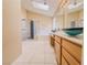 Large bathroom with double sinks, walk-in shower, and tub; skylights add abundant light at 7840 Millhopper Ave, Las Vegas, NV 89128