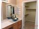 Elegantly designed bathroom with a vessel sink, vanity, and walk-in closet at 7840 Millhopper Ave, Las Vegas, NV 89128
