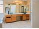 Bathroom featuring double sinks, a vanity, and a tub at 7840 Millhopper Ave, Las Vegas, NV 89128