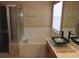 Bathroom featuring a tub, shower, and vessel sink, creating a spa-like experience at 7840 Millhopper Ave, Las Vegas, NV 89128