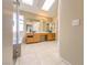 Bathroom boasts a dual vanity, glass shower, and soaking tub, perfect for relaxation at 7840 Millhopper Ave, Las Vegas, NV 89128