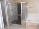 Bright bathroom with a large tub, tiled shower and neutral accents at 7840 Millhopper Ave, Las Vegas, NV 89128