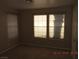 This bedroom features carpet and a large window for ample lighting at 7840 Millhopper Ave, Las Vegas, NV 89128