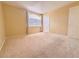 Neutral bedroom with a large window, and a door at 7840 Millhopper Ave, Las Vegas, NV 89128